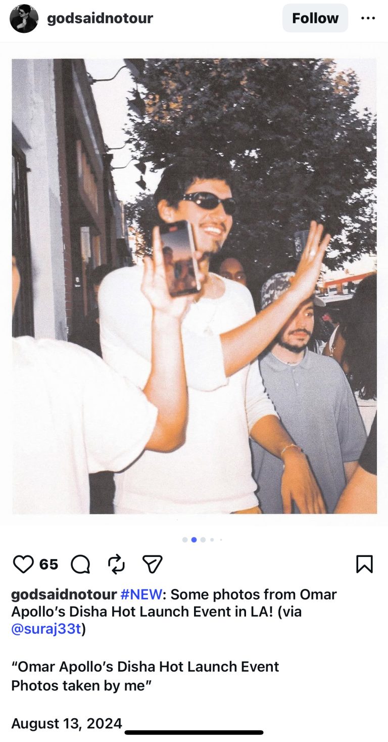 The entrance to the Tate McRae album release party. Past the entrance are fences to guide guests, and in the distance are food trucks.