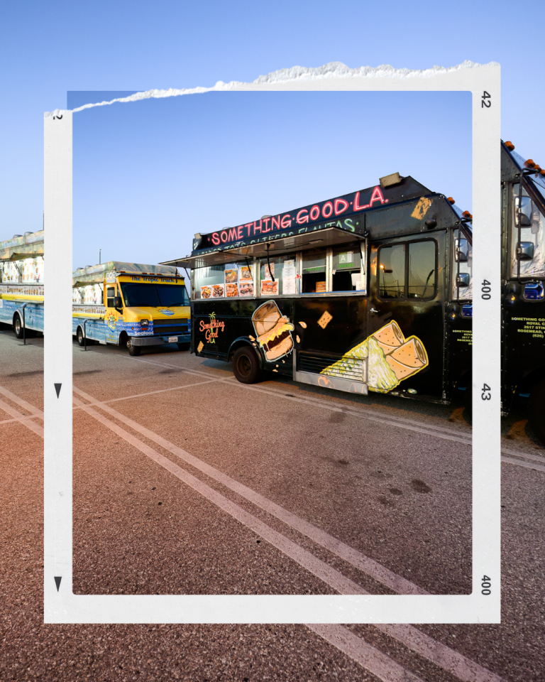 Two food trucks stationed beside each other, one black and one yellow, ready for Tate McRae's album release party.